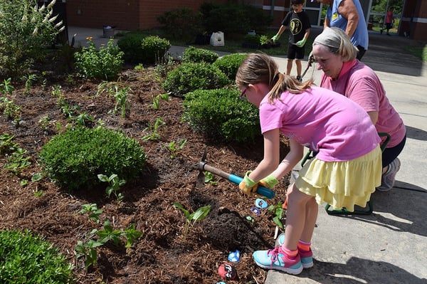 student and volunteer gardening